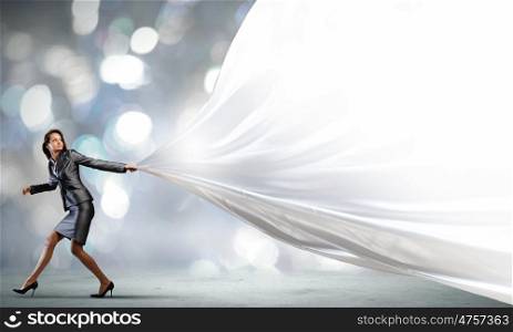 Running businesswoman. Young pretty businesswoman pulling white blank banner