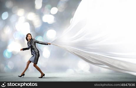 Running businesswoman. Young pretty businesswoman pulling white blank banner