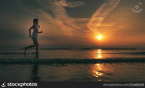 Running by the sea near the beach at dawn