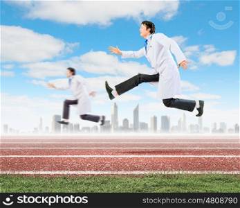 Running doctors. Image of funny doctors running at stadium