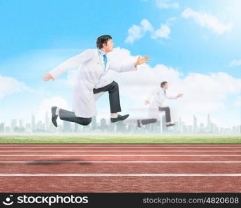 Running doctors. Image of funny doctors running at stadium