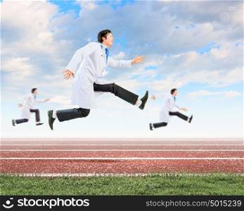 Running doctors. Image of funny doctors running at stadium