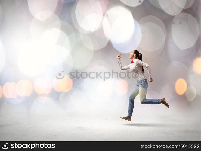 Running girl. Young woman in casual running in a hurry