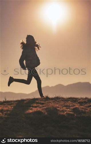 Running in the Meadows. A little girl in silhouette