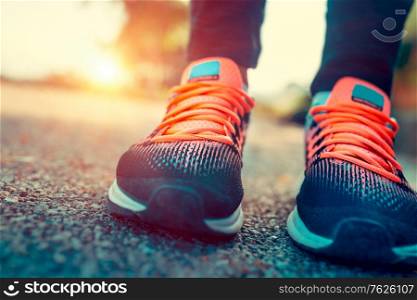 Running in the sunny summer day, closeup photo of a women&rsquo;s sportive shoes, body part, female feet, training outdoors, healthy sportive lifestyle