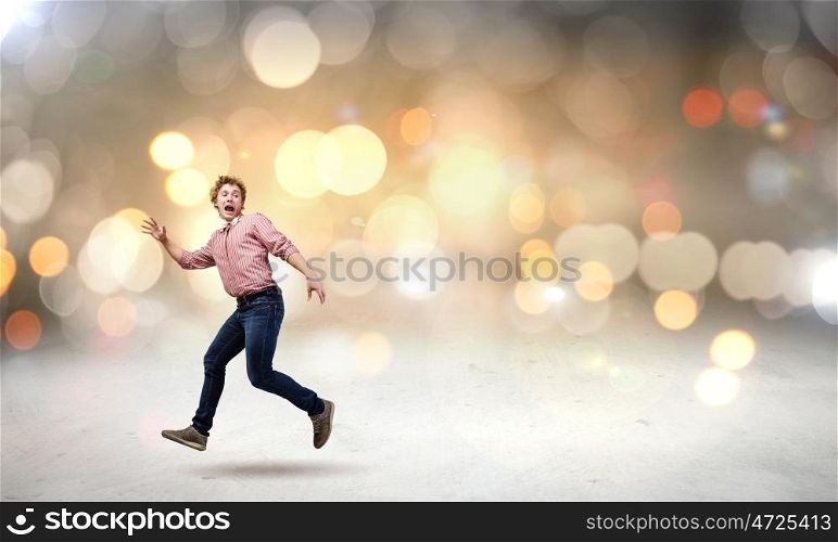 Running man. Young man in casual running away from something
