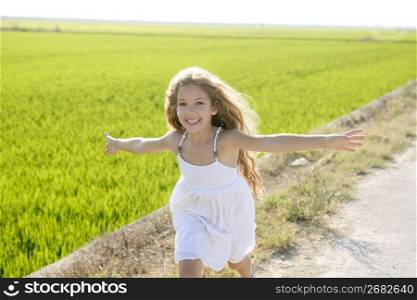running open arms little happy girl green meadow field track