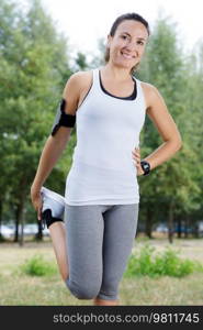 running runner woman stretching leg muscle preparing for trail-run