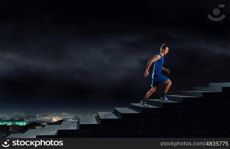 Running sportman . Young man athlete in blue wear running outdoor