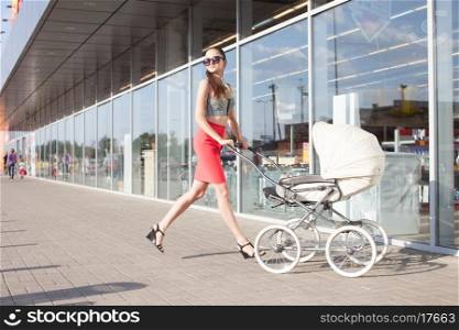 Running Trendy mother and baby in stroller