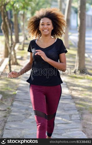 Running woman. Black Female Runner Jogging during Outdoor Workout in a Park. Beautiful fit Girl. Fitness model outdoors. Weight Loss