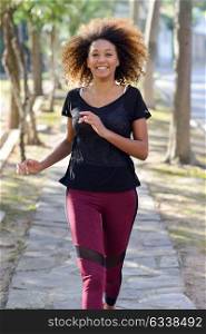 Running woman. Black Female Runner Jogging during Outdoor Workout in a Park. Beautiful fit Girl. Fitness model outdoors. Weight Loss