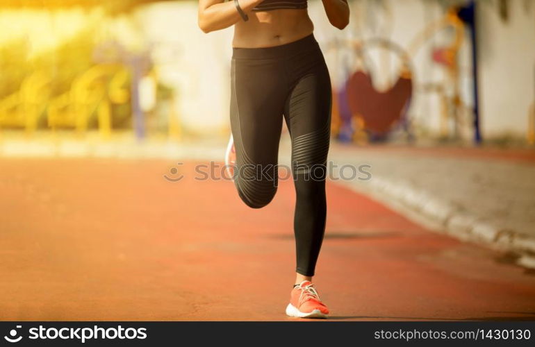 Running woman. Female runner jogging during outdoor on road .Young mixed race girl jogging