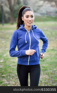 Running woman. Female Runner Jogging during Outdoor Workout in a Park. Beautiful fit Girl. Fitness model outdoors. Weight Loss