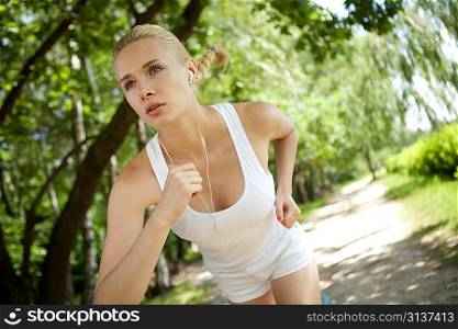 Running woman in park in summer training.
