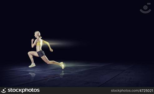 Running woman in sport wear on black background. At full speed