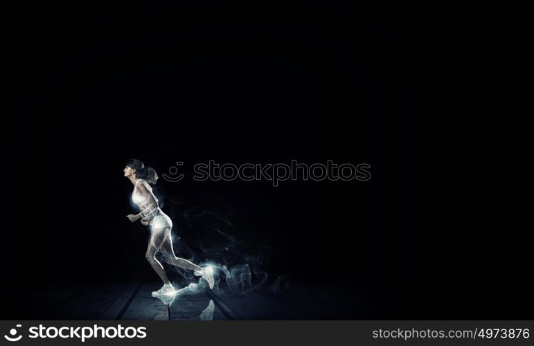 Running woman in sport wear on black background. At full speed