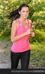 Running woman outdoor with headphones close-up