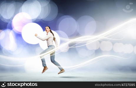 Running woman. Young funny pretty woman in jeans running in a hurry