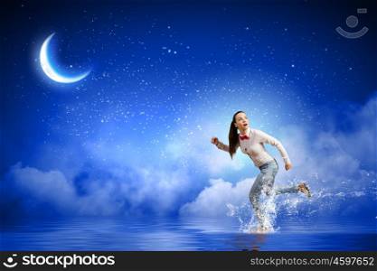 Running woman. Young scared woman running at night under moon light
