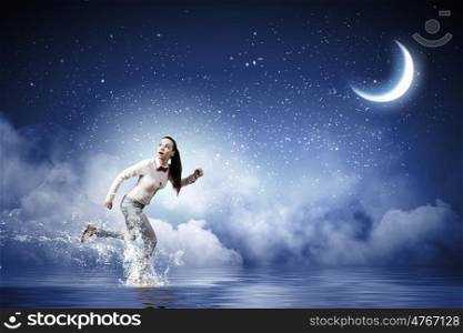 Running woman. Young scared woman running at night under moon light