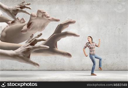 Running woman. Young woman in casual escaping from big male hand