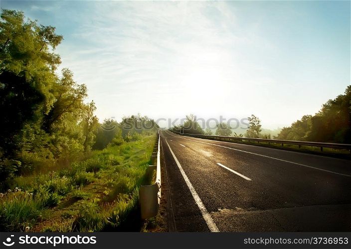 Rural asphalt road in the morning sun