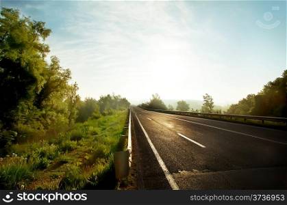 Rural asphalt road in the morning sun