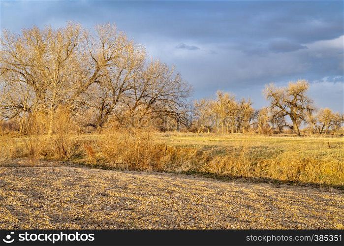 rural Colorado landscape along the South Platte River in a dramatic sunset light