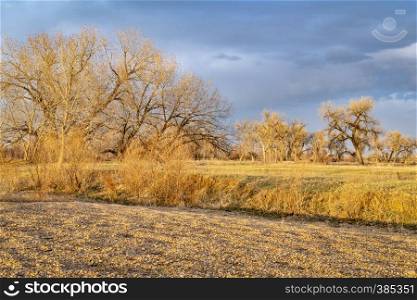 rural Colorado landscape along the South Platte River in a dramatic sunset light