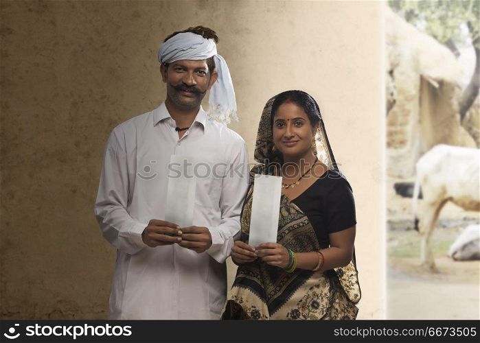 Rural couple holding bank cheque