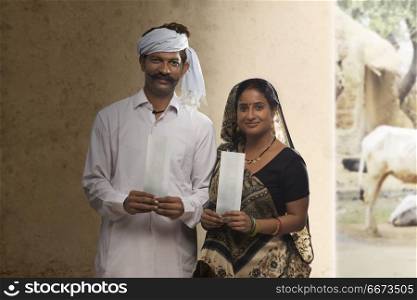 Rural couple holding bank cheque