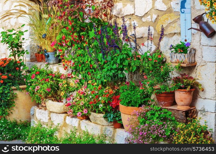 Rural house decorated with flowers in pots, Gourdon France