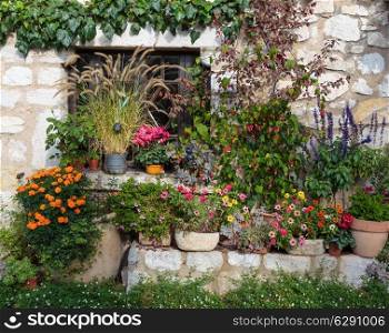 Rural house decorated with flowers in pots, Gourdon France