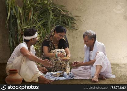 Rural Indian farmer family having lunch in field