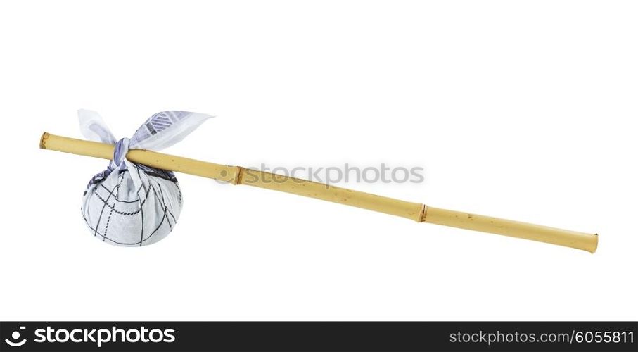 Rural knapsack on a bamboo pole isolated on white background