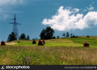Rural landscape in Carpatian mountains in summer and electrified track