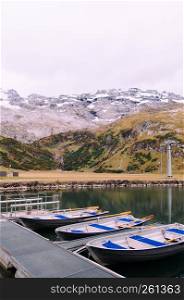Rural landscape scenery with row boats in Trubsee lake, recreation activity of Swiss alps and foot of mount Titlis area in Engelberg