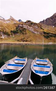 Rural landscape scenery with row boats in Trubsee lake, recreation activity of Swiss alps and foot of mount Titlis area in Engelberg