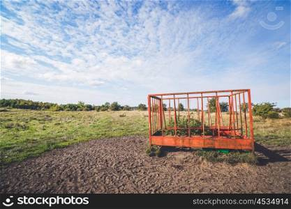 Rural landscape with a cage on a field in the summer