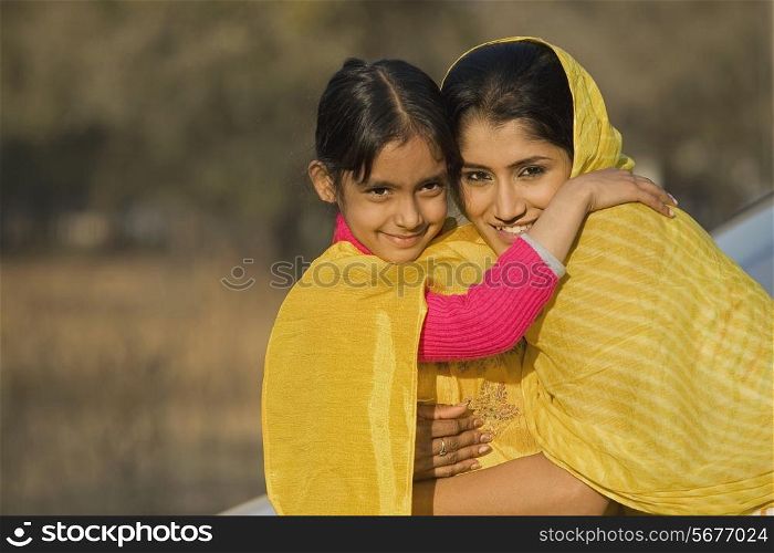 Rural mother hugging her daughter