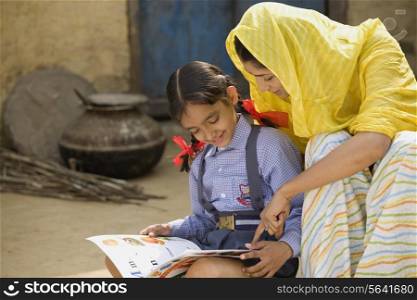 Rural mother reading with her daughter