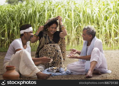 Rural woman serving lunch to farmers in field