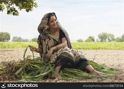 Rural woman sitting in the paddy field