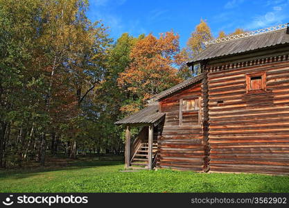 rural wooden house amongst autumn wood