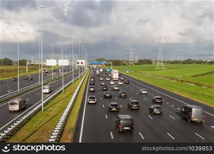 Rush hour at Dutch motorway A1 near Amsterdam with fourteen driving lanes. Dutch motorway A1 near Amsterdam with fourteen driving lanes