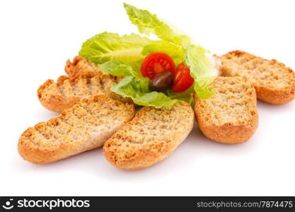 Rusks and vegetables isolated on white background.