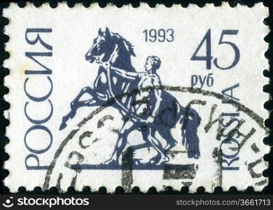 RUSSIA - CIRCA 1992: A stamp printed in Russia shows Sculpture rider leading the horse by the bridle on Anichkov Bridge in St Petersburg, circa 1992