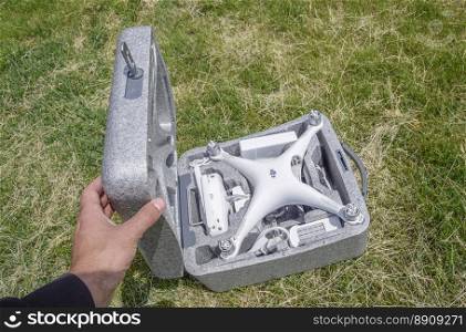 Russia, Poltavskaya village - May 13, 2016: Open case with quadrocopters DJI Phantom 4. The opening of the box on the lawn.. Open case with quadrocopters DJI Phantom 4