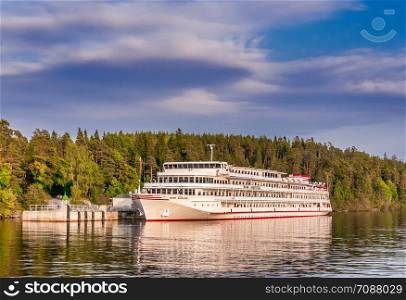 Russia, St. Petersburg - September 04, 2018: White ship standing at the pier of Valaam Island. White ship standing at the pier of Valaam Island